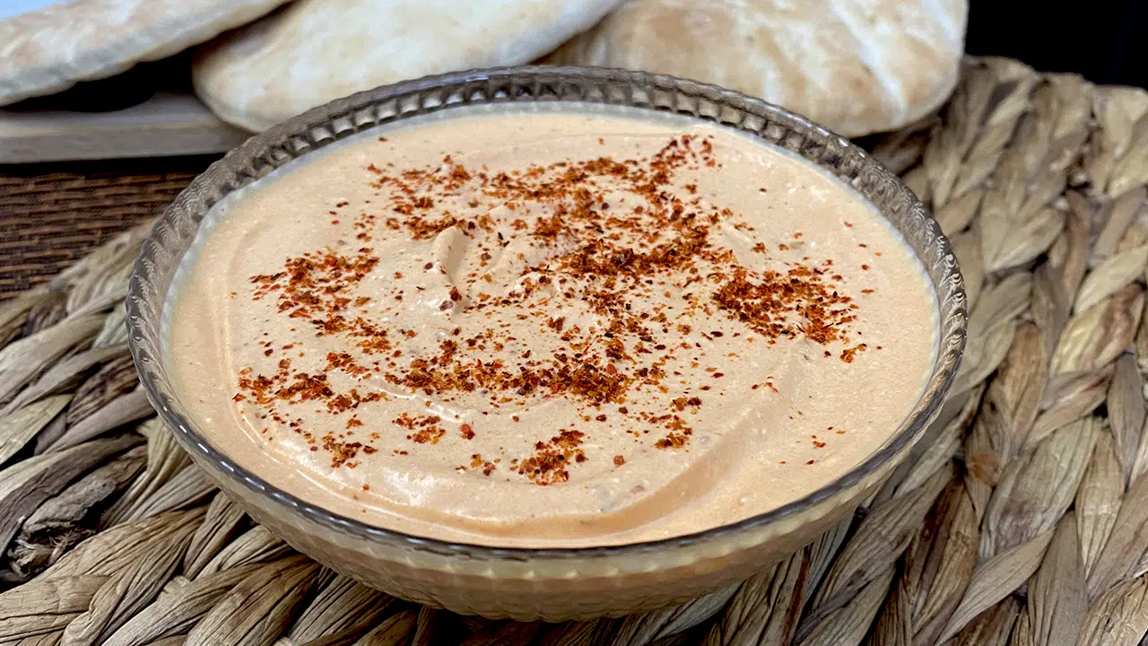 Infographic showing a step-by-step guide to making authentic Tirokafteri, a Greek spicy feta dip, with ingredients like feta cheese, olive oil, Greek yoghurt, garlic, and chillies.